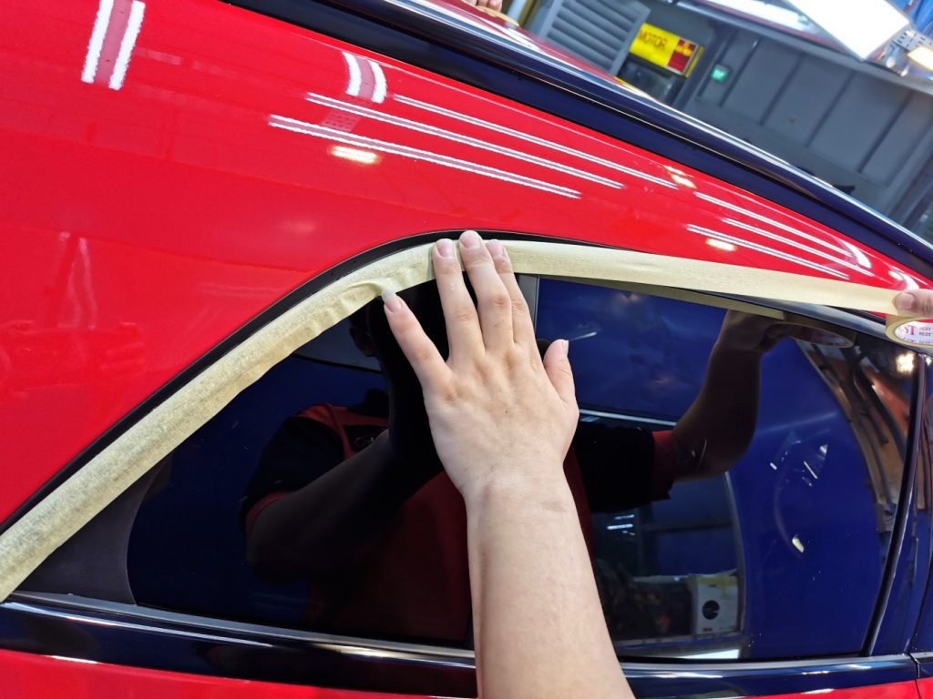 Taping rubber trims before coating